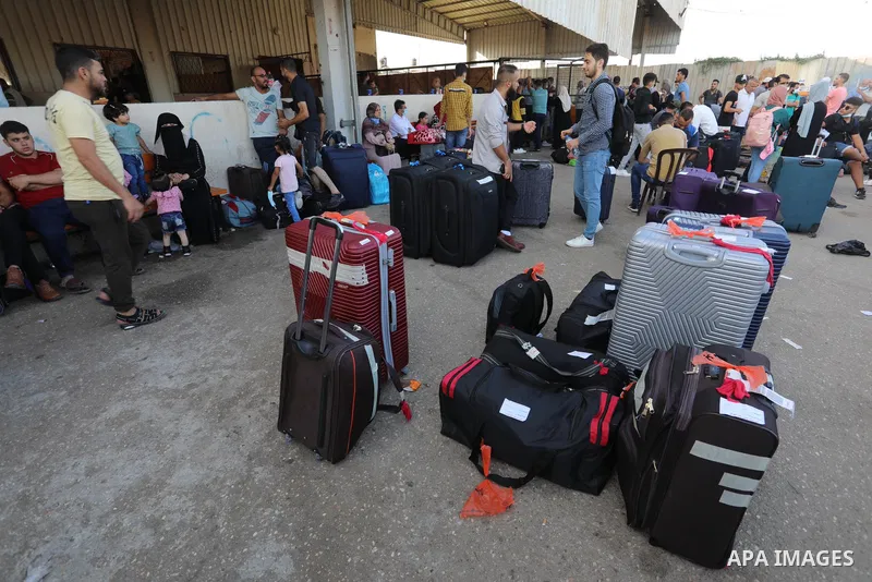 Palestinians wearing protective masks amid the COVID-19 pandemic, as they wait for travel permits to cross into Egypt through the Rafah border crossing, in Rafah in the southern of Gaza Strip, on August 29, 2021. Egypt o...