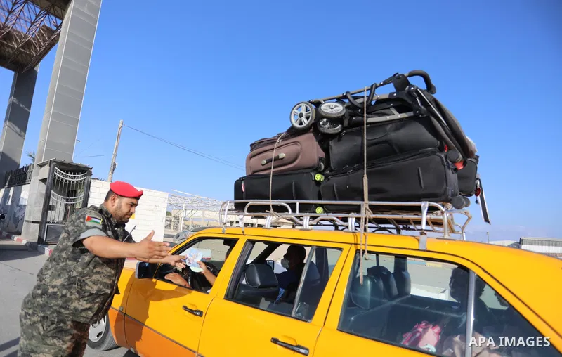 Palestinians wearing protective masks amid the COVID-19 pandemic, as they wait for travel permits to cross into Egypt through the Rafah border crossing, in Rafah in the southern of Gaza Strip, on August 29, 2021. Egypt o...