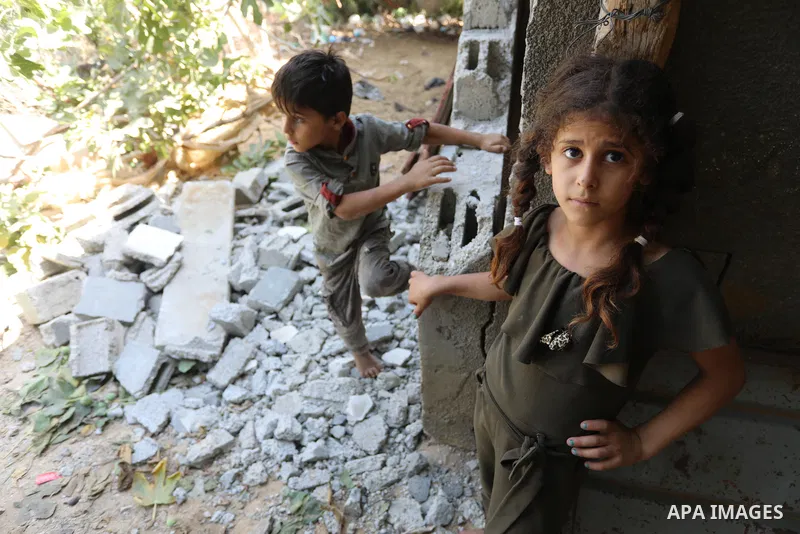 A Palestinian family inspect their home destroyed by Israeli strikes, in Beit Hanoun, northern Gaza Strip on August 29, 2021. Israeli fighter jets attacked two locations in Gaza late last night, resulting in physical dam...