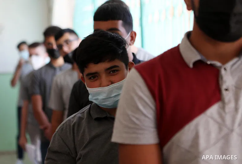 A medical worker administers a dose of the COVID-19 vaccine during vaccination drive for young students, at a school in the West Bank city Hebron, on August 30, 2021. Photo by Mamoun Wazwaz