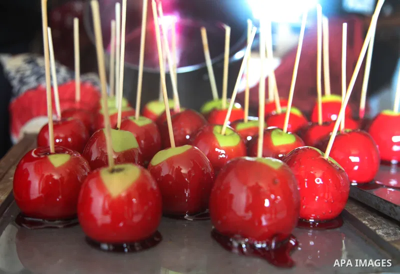 Palestinian Hanan Hamad, 50, makes apple candy with colored honey known in Gazans as "Anber" at her home, before sell its to customers which was the only source of livelihood for her and her family of 14 people, in Beit...