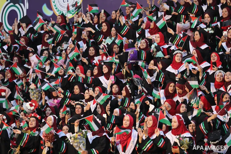 Palestinian students attend their graduation ceremony at Palestine university at Al-Zahra city in the center of Gaza Strip on July 29, 2021. Photo by Ashraf Amra