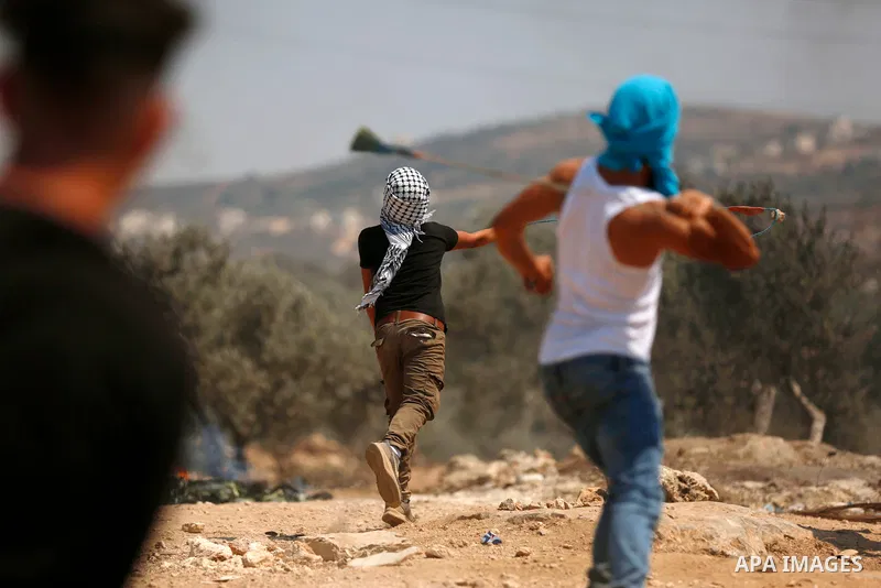 Palestinian protesters clash with Israeli forces in the town of Beita, near the occupied West Bank city of Nablus, on July 30, 2021, after a protest against the Israeli outpost of Eviatar. Photo by Shadi Jarar'ah