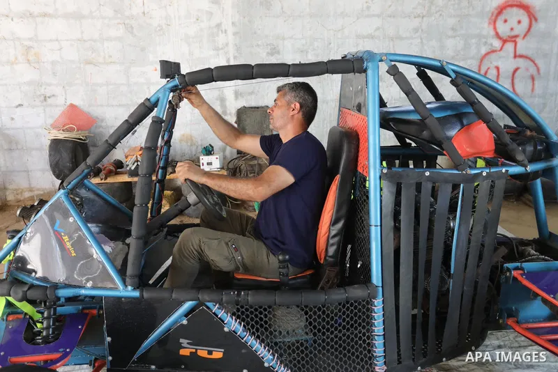 Palestinian Fathi Abu Gharaba, 46, invents a racing car in Maghazi refugee camp in the central Gaza Strip, on July 31, 2021. Using scrap materials and rudimentary equipment at a cost of US$3500, Abu Gharaba produces a "d...