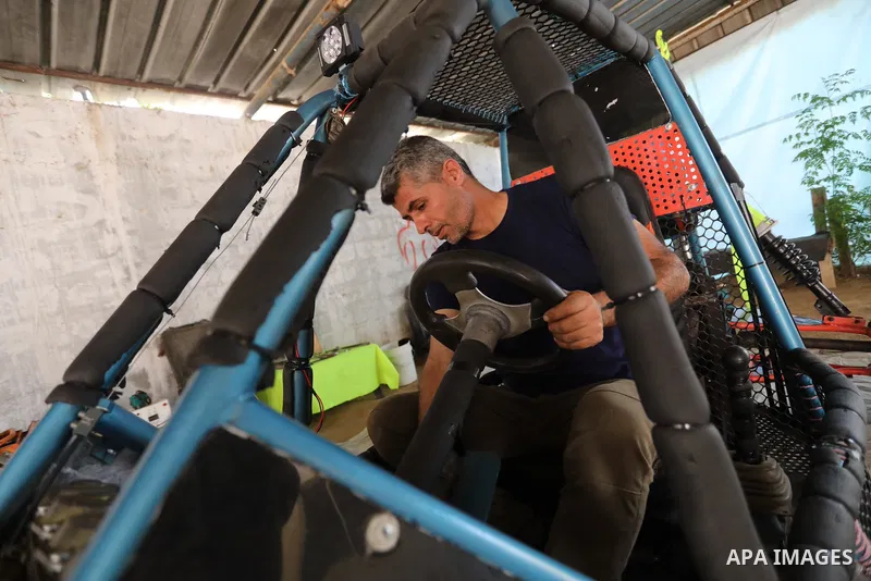 Palestinian Fathi Abu Gharaba, 46, invents a racing car in Maghazi refugee camp in the central Gaza Strip, on July 31, 2021. Using scrap materials and rudimentary equipment at a cost of US$3500, Abu Gharaba produces a "d...