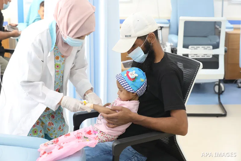 Palestinian clowns play with a child with cancer at el-Rantisi hospital in Gaza city on August 01, 2021. 2020 has been a rough year for cancer patients in the Gaza Strip. The usual restrictions and blockade were compound...
