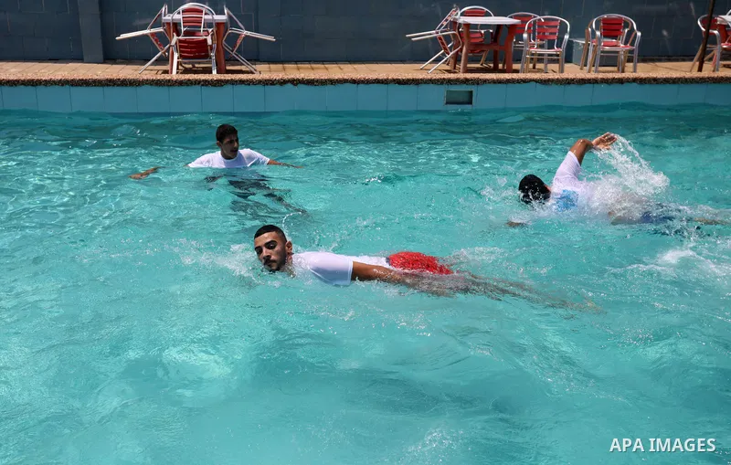 Palestinian amputee youths and children swim in a pool during a summer camp "Ability camp", in Gaza city on August 1, 2021. Photo by Ashraf Amra
