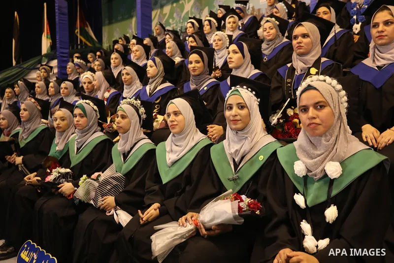 A picture taken on August 1, 2021 shows Palestinian students attend their graduation ceremony at University College of Applied Sciences (UCAS), in Gaza city. Photo by Ashraf Amra