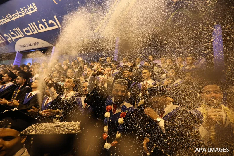 A picture taken on August 1, 2021 shows Palestinian students attend their graduation ceremony at University College of Applied Sciences (UCAS), in Gaza city. Photo by Ashraf Amra