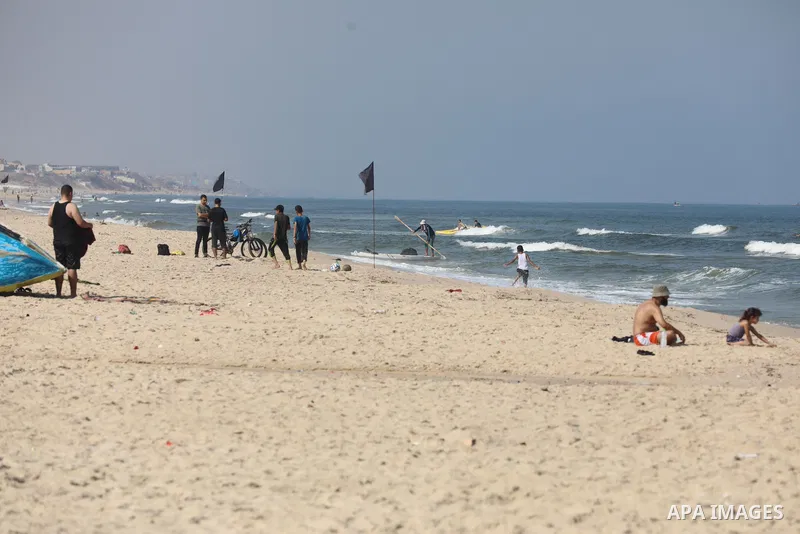 Palestinians enjoy the beach of the Mediterranean sea in Gaza City, on August 2, 2021. The beach is one of the few open public spaces in this densely populated city. Photo by Ashraf Amra
