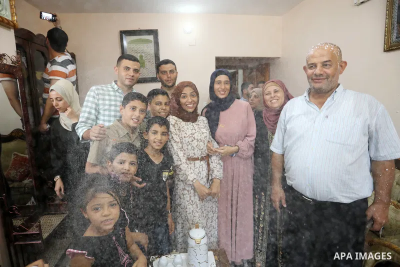 A Palestinian high school female student, Ghaida Radi, 99.4%, celebrates with her family after heard the results of her final exams known as ''Tawjihi'', in Khan Younis in the southern of Gaza strip on August 3, 2021. Ph...