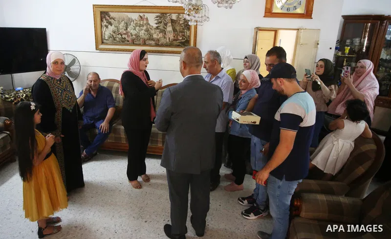 A Palestinian high school female student, Tala Hajab, 99.7%, celebrates with her family after heard the results of her final exams known as ''Tawjihi'', in the West Bank city of Nablus on August 3, 2021. Photo by Shadi J...