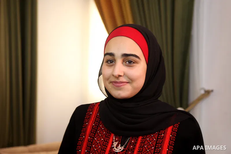 A Palestinian high school female student, Wafaa Fares, 99.7%, celebrates with her family after heard the results of her final exams known as ''Tawjihi'', in Gaza city on August 3, 2021. Photo by Omar Ashtawy