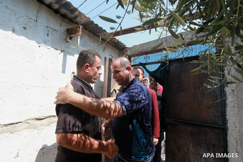 The family of a Palestinian high school student Khaled Qanooa, who killed during the recent conflict between Israel and Hamas, sit at thier home during the results of final exams known as "Tawjihi", in Gaza city on Augus...