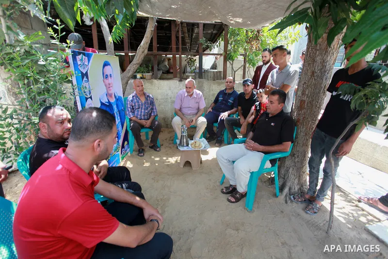 The family of a Palestinian high school student Khaled Qanooa, who killed during the recent conflict between Israel and Hamas, sit at thier home during the results of final exams known as "Tawjihi", in Gaza city on Augus...