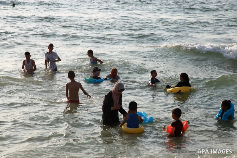 Palestinians enjoy the beach of the Mediterranean sea in Gaza City, on August 6, 2021. The beach is one of the few open public spaces in this densely populated city. Photo by Omar Ashtawy