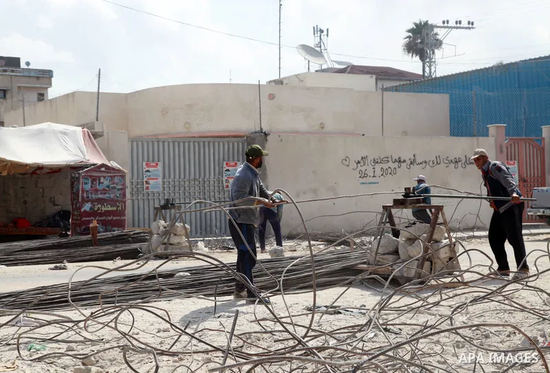Palestinian workers remove the rubble of Jala' Tower recently destroyed by Israeli strikes in Gaza City, on August 8, 2021. Al-Sisi also promised $500 million for rebuilding Gaza, and gave directives to Egyptian state in...