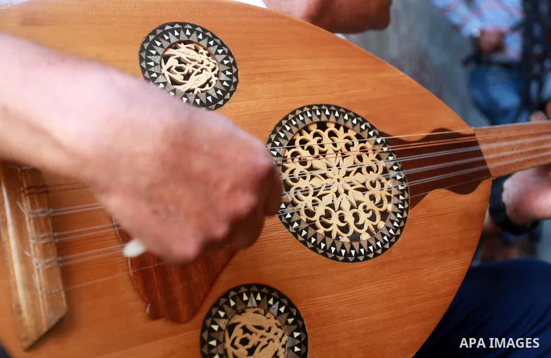 Palestinian refugee, Kamal Abu Ghabin, 57, plays the lute known in Arabic as an "Oud", during his rest, in Gaza city, on August 8, 2021. Abu Ghabin works as a blacksmith and has been playing the oud since his childhood....