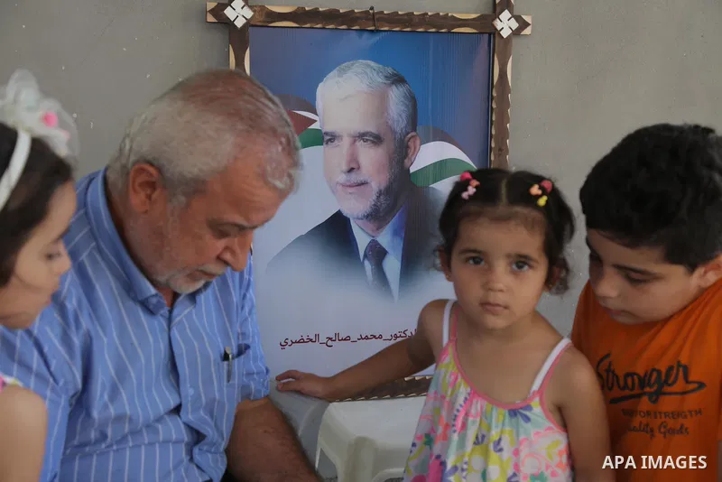 Abd al-Majid al-Khudari, brother of the prisoner Mohammad al-Khudari who is detained in Saudi Jails, looks on the mobile at his home in Gaza city on August 09, 2021. The Saudi court issued verdicts against 69 Palestinian...