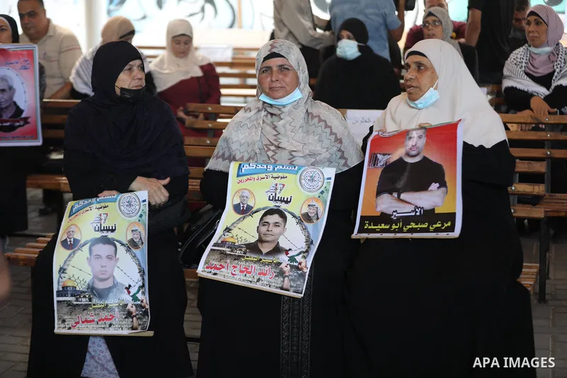 Palestinians take part in a protest to show solidarity with prisoners on hunger strike in Israeli Jails, in front of the headquarters of Red cross in Gaza city on August 09, 2021. A total of 13 Palestinian prisoners in I...