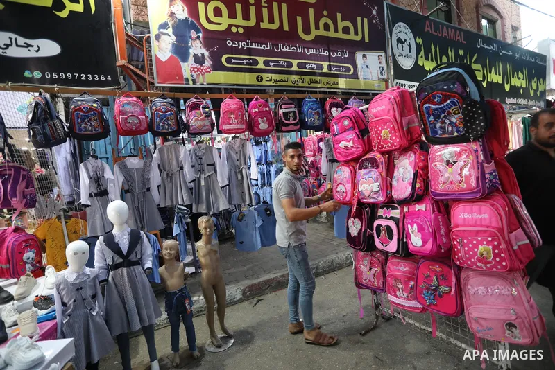 Palestinians shop during preparation for the new school year at a market in Nuseirat refugee camp in the center of the Gaza Strip, on 11 August 2021. The fiscal position in Gaza strip has worsened not only due to the out...