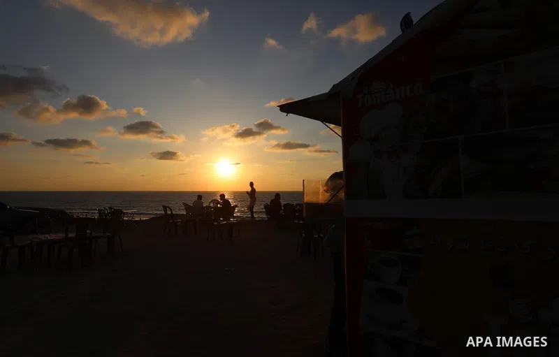 Palestinian graduates work on a small cafe "Tomanco", on the beach of the Mediterranean sea in Deir al-Balah in the central Gaza Strip, on August 14, 2021. Palestinian Abu Shadi Toman opened a small cafe on the beach of...