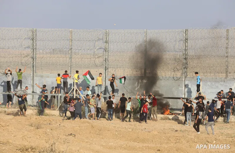 Palestinians clash with Israeli security forces following a demonstration along the Israel-Gaza border, east of Gaza city on the 52nd anniversary of the burning of the blessed Al-Aqsa Mosque, on August 21, 2021. Today, S...