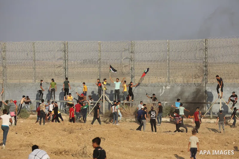 Palestinians clash with Israeli security forces following a demonstration along the Israel-Gaza border, east of Gaza city on the 52nd anniversary of the burning of the blessed Al-Aqsa Mosque, on August 21, 2021. Today, S...