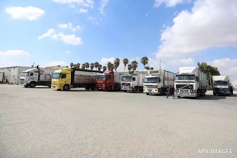 Trucks loaded with goods and fuel enter the Gaza Strip from Israel through the Kerem Shalom crossing in Rafah in the southern Gaza Strip on August 23, 2021. Israel had banned the entry of the construction materials into...