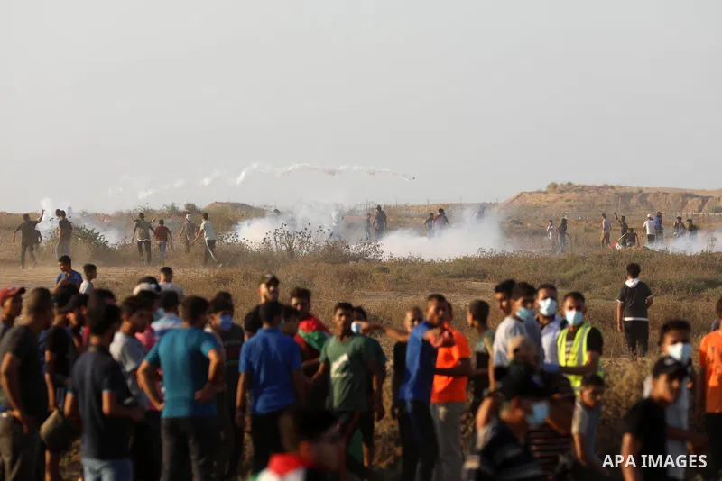 Palestinian demonstrators gather during a protest along the border fence, east of Khan Yunis in the southern Gaza Strip, on August 25, 2021. Palestinian groups in Gaza have pledged to continue protests along the border t...