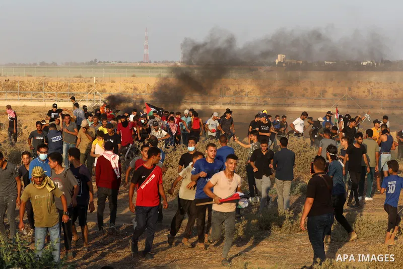 Palestinian demonstrators gather during a protest along the border fence, east of Khan Yunis in the southern Gaza Strip, on August 25, 2021. Palestinian groups in Gaza have pledged to continue protests along the border t...