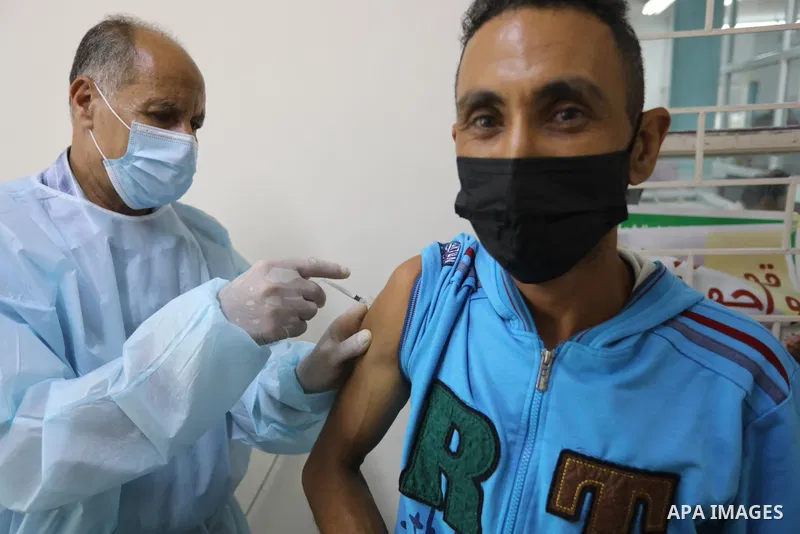 Palestinians get inoculated with a dose of the Covishield vaccine against the Covid-19 coronavirus, at a temporary vaccination centre set up, in Deir Al Balah in the center of Gaza strip on August 26, 2021. Minister of H...