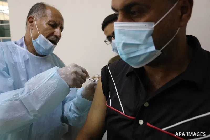 Palestinians get inoculated with a dose of the Covishield vaccine against the Covid-19 coronavirus, at a temporary vaccination centre set up, in Deir Al Balah in the center of Gaza strip on August 26, 2021. Minister of H...