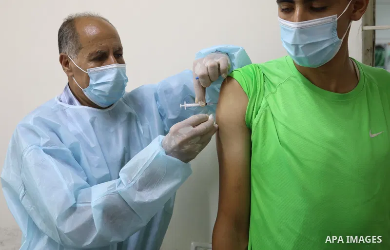 Palestinians get inoculated with a dose of the Covishield vaccine against the Covid-19 coronavirus, at a temporary vaccination centre set up, in Deir Al Balah in the center of Gaza strip on August 26, 2021. Minister of H...