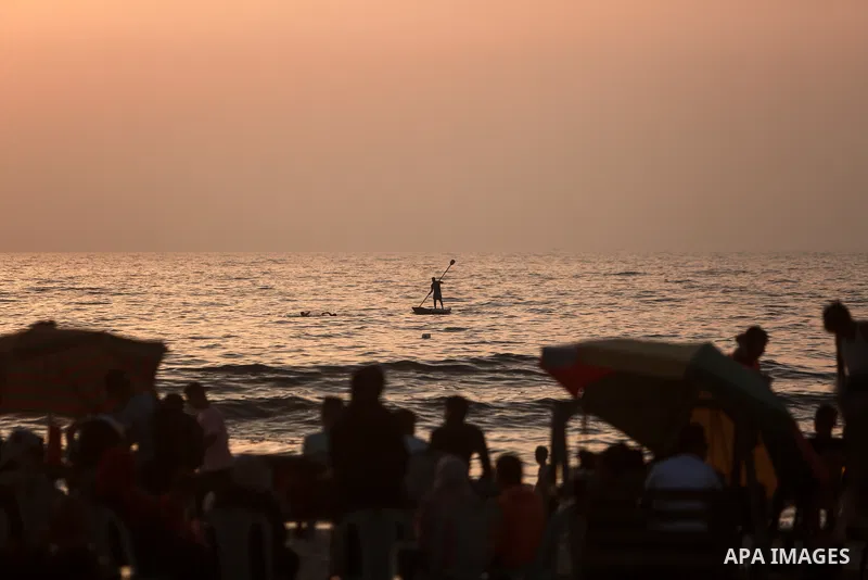 Palestinians spend time at a beach in Gaza July 2, 2021 as temperatures soar in the coastal Palestinian enclave. Photo by Mohammed Dahman