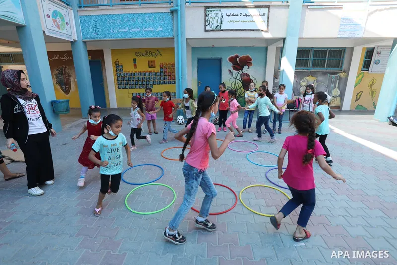 Palestinian schoolgirls enjoy as part of the activities proposed during a summer camp by run by the United Nations Relief and Works Agency (UNRWA) at Nuseirat refugee camp, in the center of Gaza Strip on July 04, 2021. T...