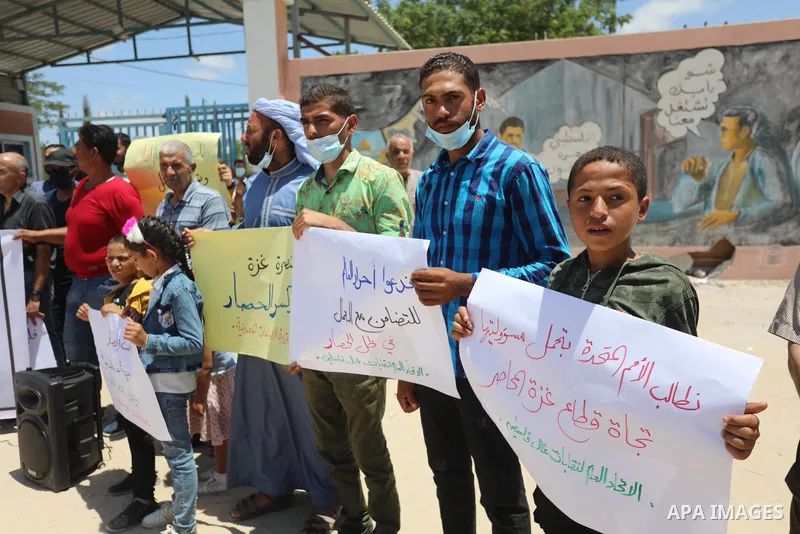 Palestinian workers take part in a protest against the Israeli blockade on Gaza Strip, in front of Erez crossing, in Beit Hanoun in the northern Gaza Strip on July 04, 2021. Israel and Hamas have fought on-and-off since...