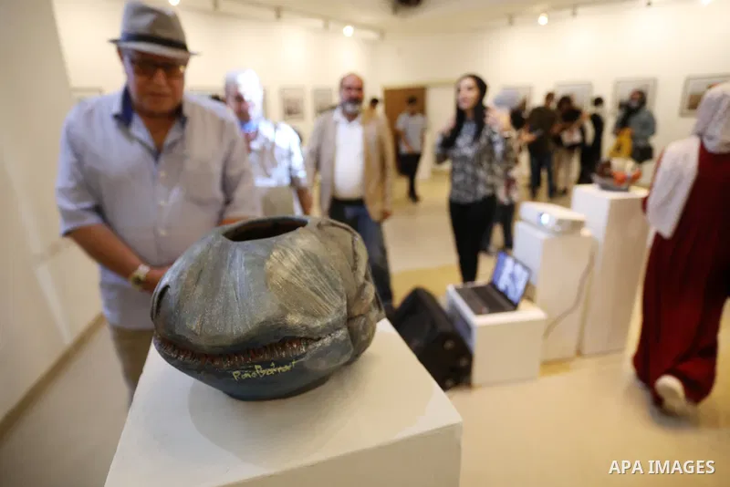Palestinians attend an exhibition of photos and sculptures "Scenes from Palestine" by artist Rana El-Batrawi in Gaza City, on July 05, 2021. Photo by Ashraf Amra