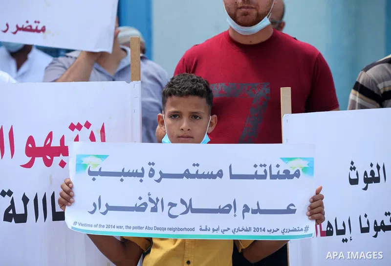 Palestinian owners of houses which were destroyed during the Israeli war of 2014, take part in a rally demanding for reconstruction of their houses, outside the United Nations Relief and Works Agency (UNRWA) in Gaza city...