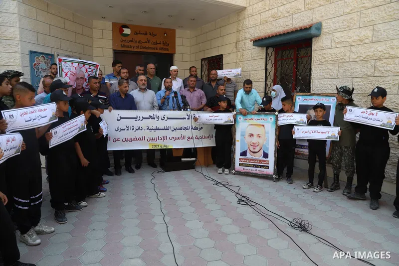 Palestinians hold placards during a protest in solidarity with prisoner in Israeli jails Ghadanfar Abu Atwan, in Gaza city on July 6, 2021. Palestinian prisoner in Israeli jails, Ghadanfar Abu Atwan, continues his hunger...