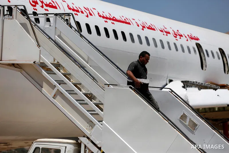 Palestinians stand on a retired Boeing airplane owned by Palestinian twin Atta and Khamis Al-Serafy, which standing in an empty ground before converting into a restaurant near the West Bank city of Nablus, 05 July 2021....