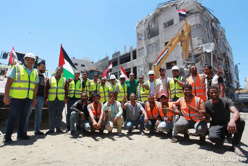 Egyptian workers end thier work on clear the remaining rubble of the Shouroq tower a building that was levelled in an Israeli attack during the 11-day conflict between Israel and the Palestinian Hamas movement in May thi...