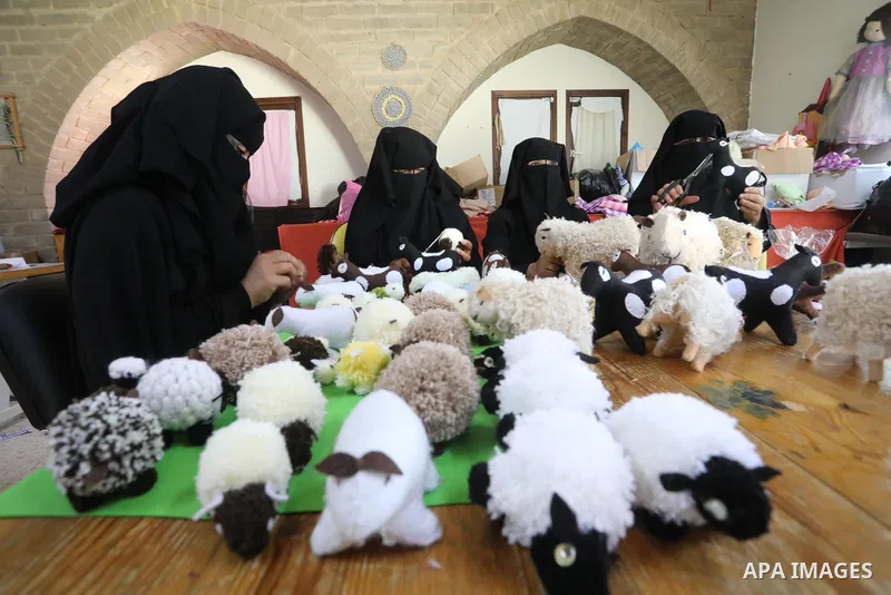 Palestinian women sew Eid al-Adha toys in the Bedouin village of "Umm Al-Nasr" in the northern Gaza Strip, on July 12, 2021. Eid al-Adha, or the feast of sacrifice, falls at this month when Muslims will slaughter sheep,...
