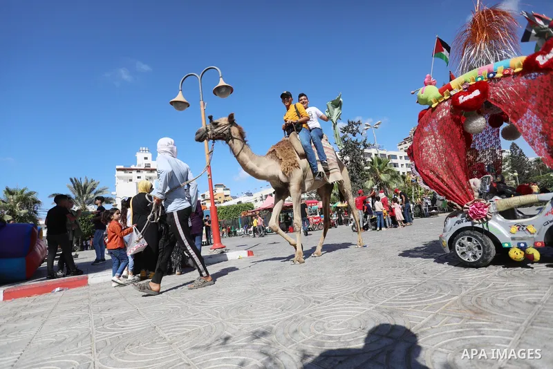 Palestinian children play at a park during the second day of Eid al-Adha festival celebrated by Muslims worldwide, in Gaza City on July 21, 2021. The al-Adha, or "Feast of Sacrifice", marks the end of the annual pilgrima...