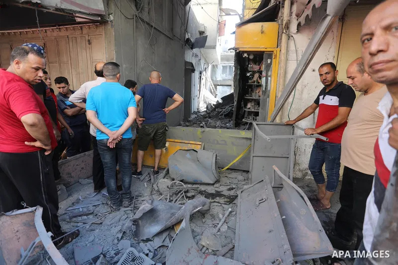 Palestinians gather at the scene of a blast in Gaza City, the cause of which has not yet been determined, on July 22, 2021. Photo by Ashraf Amra