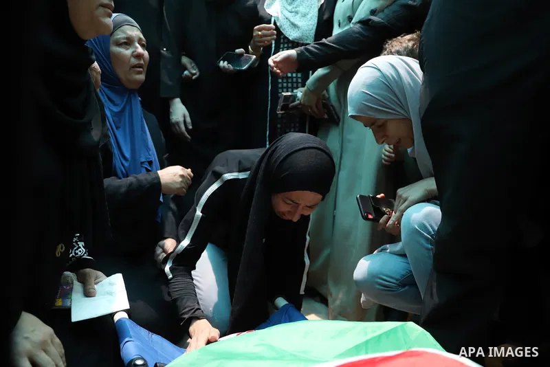 Palestinians carry the body of Muhammad Munir al-Tamimi during his funeral in Deir Nizam, west of Ramallah city in the occupied West Bank, on July 24, 2021. Al-Tamimi has died after being shot during clashes with Israeli...