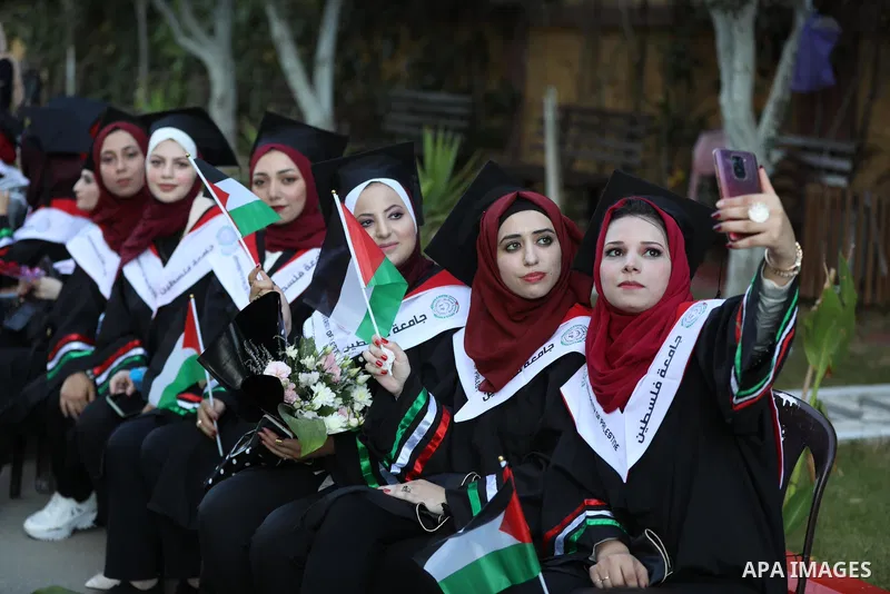 Palestinian female students attend their graduation ceremony at Palestine university at Al-Zahra city in the center of Gaza Strip on July 28, 2021. Photo by Ashraf Amra