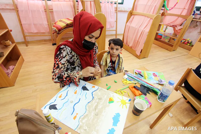 Palestinian children and their mothers participate in an awareness activity related to some correct concepts at Qattan Foundation in Gaza city on July 28, 2021. With schools shuttered due to coronavirus and the summer hi...