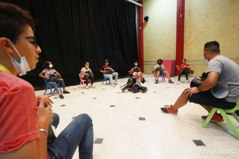 Palestinian children attend a class to learn Darbuka (goblet drum) in Gaza city on July 29, 2021. With schools shuttered due to coronavirus and the summer hiatus, Gaza's children have little to keep them occupied. Photo...