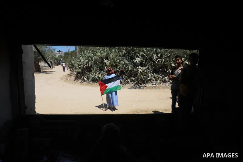 Palestinians take part in an event entitled "The return march is salt of the land and the homeland" near the border fence with Israel, in Maghazi refugee camp in the central Gaza Strip on July 1, 2021. Photo by Ashraf Am...